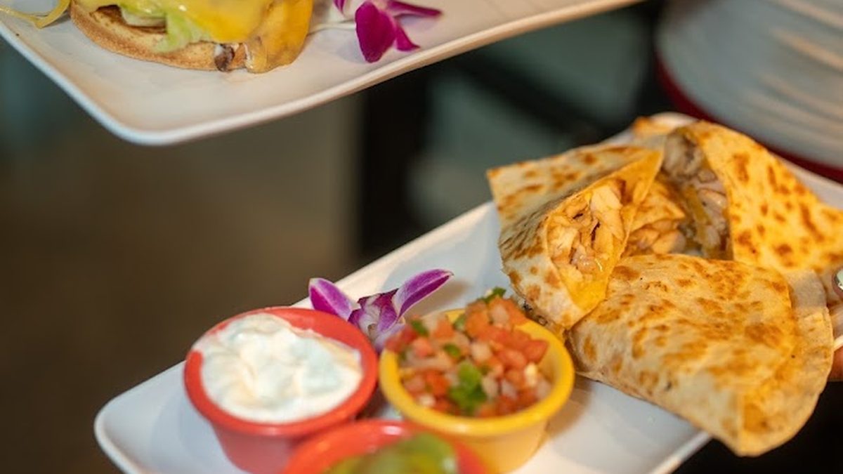 Burger with fries and Quarterback quesadilla at Skybox Taphouse Waikiki